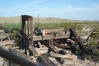 Half of a massive wheel under the remains of its supports