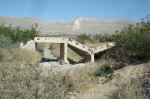 The ruins of an old concrete bridge across the drainage