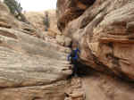 Janice climbing down some steep rocks
